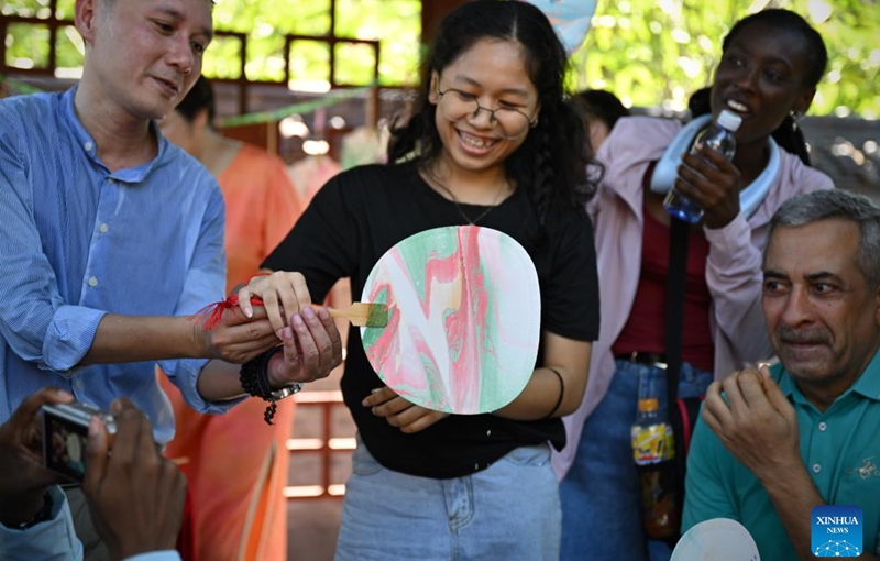 Foreigners learn to make traditional Chinese lacquer fans in Haikou, south China's Hainan Province, July 6, 2024. Photo: Xinhua