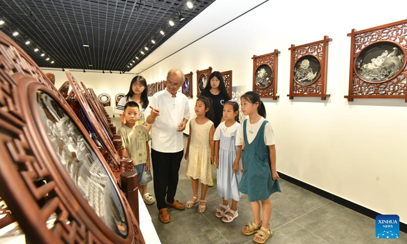 Pupils learn about the technique of porcelain carving at a museum in Hejian, north China's Hebei Province, July 26, 2024. Various training courses on intangible cultural heritages as shadow puppet, porcelain carving etc. targeting the school children are opened in the city during the summer vacation. Photo: Xinhua