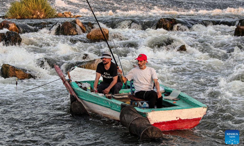 Fishermen fish at a waterfall in the Nile River in Qalyubia Governorate, Egypt, on July 6, 2024. Hundreds of amateur and professional fishermen gathered here to fish and escape the heat during hot summer. Photo: Xinhua