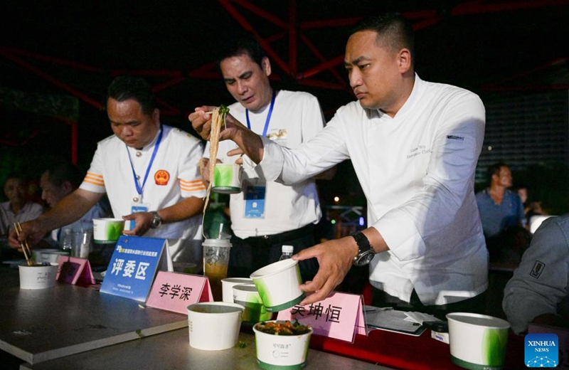 Referees taste Lingshui sour rice noodles during a sour rice noodle cooking competition in Lingshui, south China's Hainan Province, July 26, 2024. Lingshui sour rice noodle is a popular local snack and was listed as a provincial-level intangible cultural heritage in 2009. Recently a cooking competition was held in Lingshui to promote the sour rice noodle industry. Photo: Xinhua