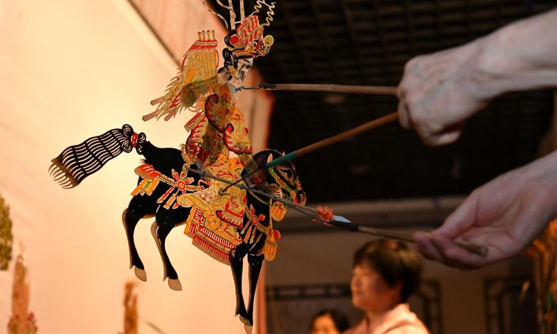 Shadow puppet artists stage a show for pupils at a primary school in Hejian, north China's Hebei Province, July 26, 2024. Various training courses on intangible cultural heritages as shadow puppet, porcelain carving etc. targeting the school children are opened in the city during the summer vacation. Photo: Xinhua