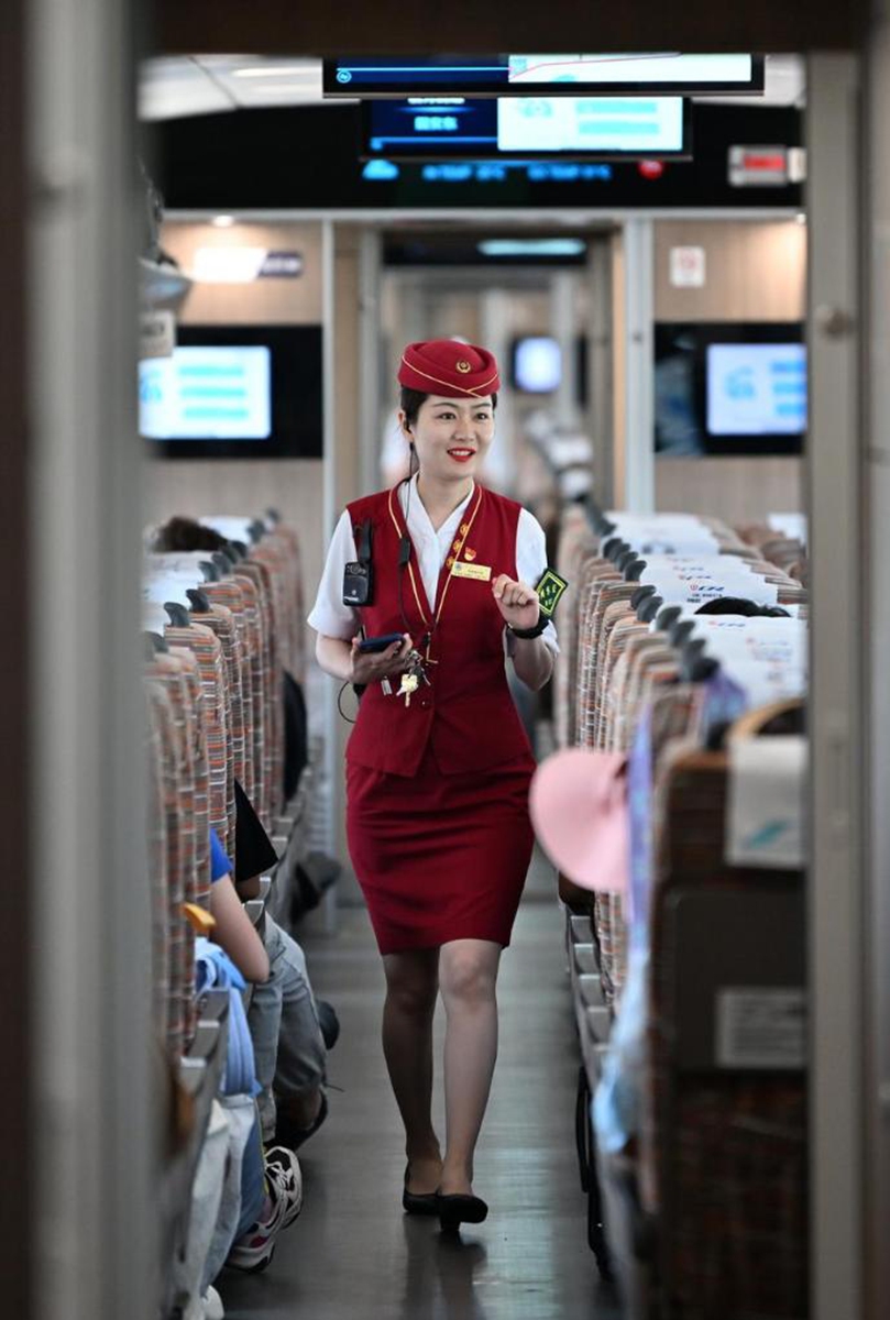 A train attendant works on the G8844 bullet train of a railway connecting north China's Tianjin Municipality with the Beijing Daxing International Airport on July 6, 2024. Photo: Xinhua