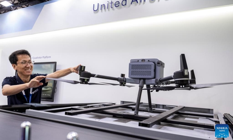 A staff member works at the booth of Shenzhen United Aircraft Technology Co., Ltd, during the Farnborough International Airshow in Farnborough, Britain, July 22, 2024. The 2024 Farnborough International Airshow closed on July 26. Photo: Xinhua