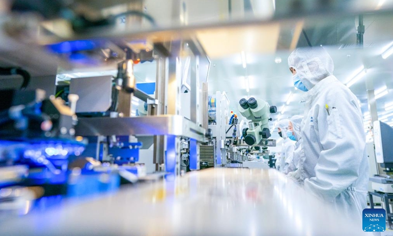 Staff members work on a production line of Accelink Technologies, an opto-electronic components supplier, in Wuhan, central China's Hubei Province, Feb. 5, 2024. Wuhan East Lake High-tech Development Zone, also known as the optics valley of China, is the birthplace of China's first optical fiber and a national optoelectronic information industry base. In recent years, Hubei Province has made major breakthroughs in the development of optoelectronic information industry and accelerated the building of optoelectronic information industry clusters. Photo: Xinhua