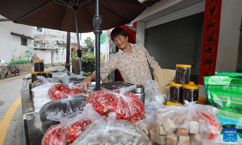 A villager sells local specialties at Shimen Village of Wuyuan County, east China's Jiangxi Province, July 3, 2024. In recent years, Wuyuan County has been making efforts to promote rural tourism by exploring and utilizing its unique natural resources and traditional culture. Photo: Xinhua