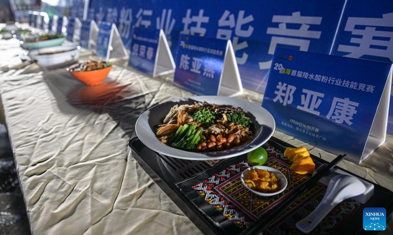 Dishes of Lingshui sour rice noodles made by competitors are pictured during a sour rice noodle cooking competition in Lingshui, south China's Hainan Province, July 26, 2024. Lingshui sour rice noodle is a popular local snack and was listed as a provincial-level intangible cultural heritage in 2009. Recently a cooking competition was held in Lingshui to promote the sour rice noodle industry. Photo: Xinhua