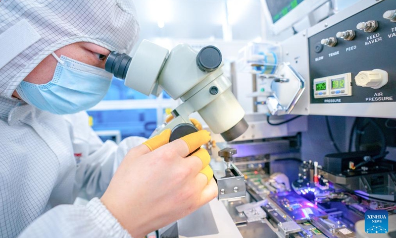 A staff member works on a production line of Accelink Technologies, an optoelectronic components supplier, in Wuhan, central China's Hubei Province, Feb. 5, 2024. Wuhan East Lake High-tech Development Zone, also known as the optics valley of China, is the birthplace of China's first optical fiber and a national optoelectronic information industry base. In recent years, Hubei Province has made major breakthroughs in the development of optoelectronic information industry and accelerated the building of optoelectronic information industry clusters. Photo: Xinhua