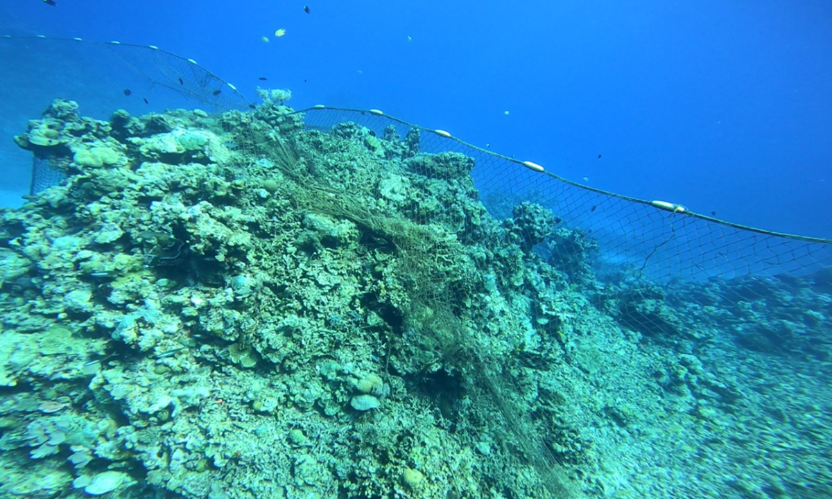 Photo taken by scientists who dived in the water near Ren'ai Jiao shows the fishing net on the east side of the illegally 