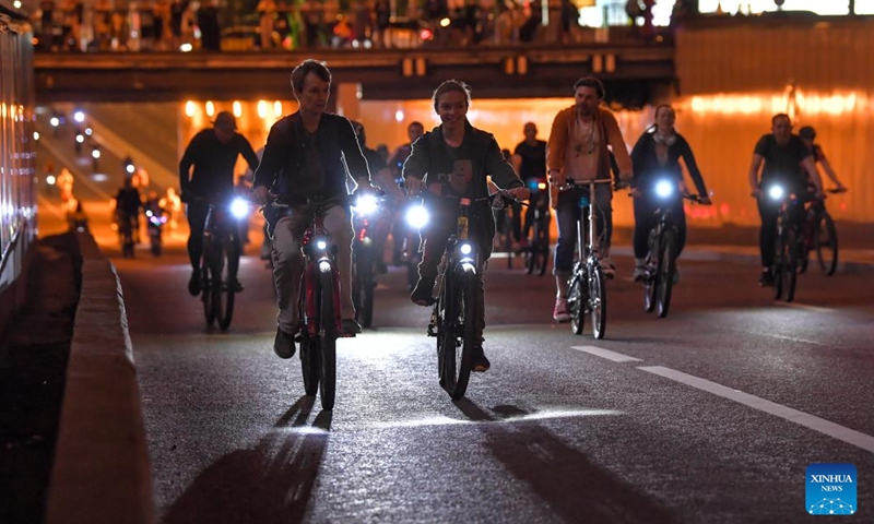 People take part in a night bicycle festival in Moscow, Russia, July 6, 2024. Thousands of people took part in the bicycle ride through the central streets of Moscow during the festival. (Photo by Alexander Zemlianichenko Jr/Xinhua)