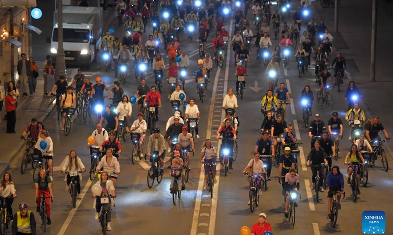 People take part in a night bicycle festival in Moscow, Russia, July 6, 2024. Thousands of people took part in the bicycle ride through the central streets of Moscow during the festival. (Photo by Alexander Zemlianichenko Jr/Xinhua)