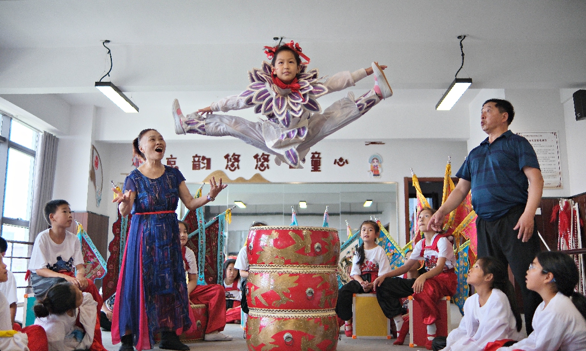 A girl practices Peking Opera skills in Hai'an, East China's Jiangsu Province, on July 8, 2024. A free summer camp was opened to teach children about Peking Opera, allowing them to experience the charm of the national cultural heritage. Photo: VCG