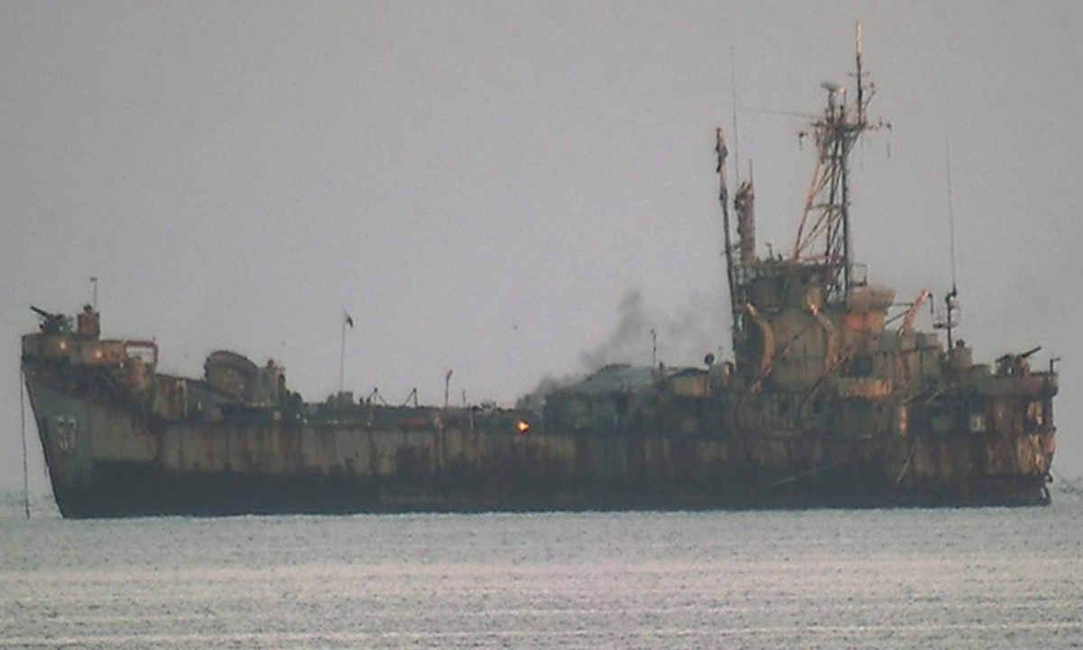 Philippine personnel burn garbage on the deck of the illegally 