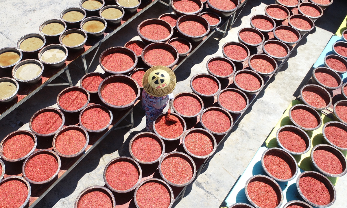 A farmer stirs chili sauce being sun-dried in the city of Loudi, Central China's Hunan Province, on July 8, 2024. With the onset of high temperatures, producers and farmers have begun sun-drying chili sauce, made from locally grown Red Lantern chili peppers, a centuries-old protected regional product.
Photo: VCG