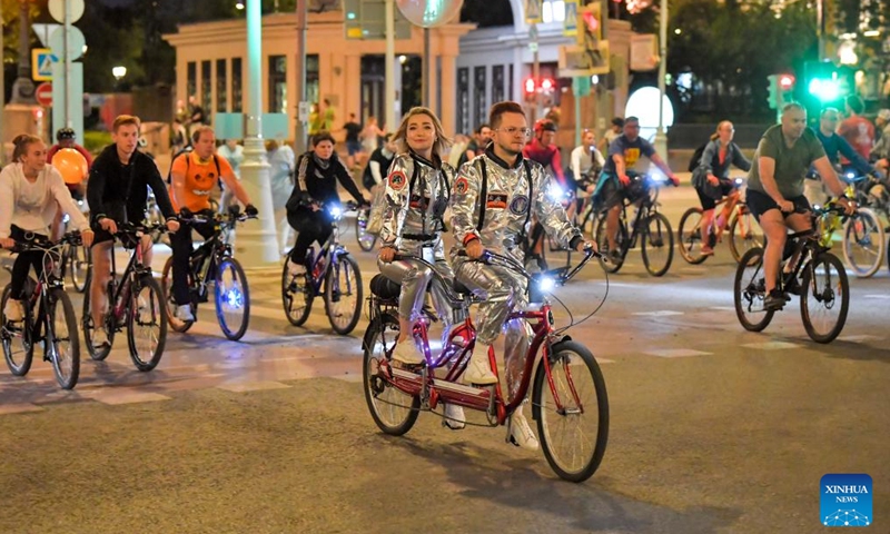 People take part in a night bicycle festival in Moscow, Russia, July 6, 2024. Thousands of people took part in the bicycle ride through the central streets of Moscow during the festival. (Photo by Alexander Zemlianichenko Jr/Xinhua)