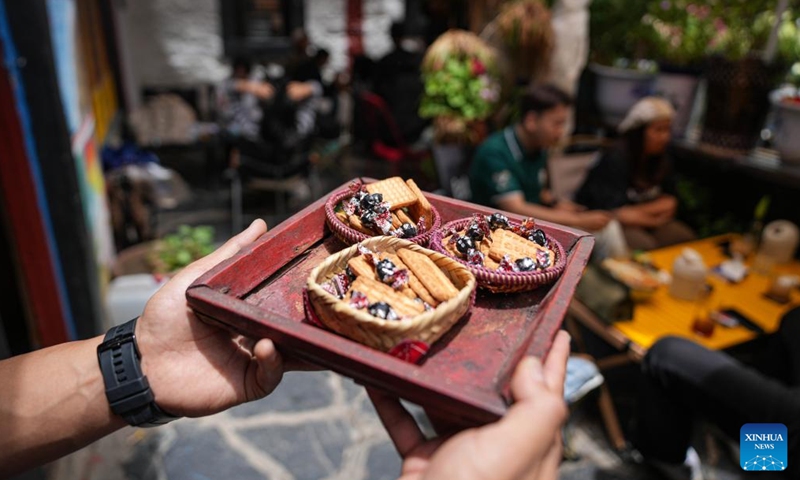 Complimentary snacks are served at a cafe on the Barkhor Street in Lhasa, southwest China's Xizang Autonomous Region, July 5, 2024.