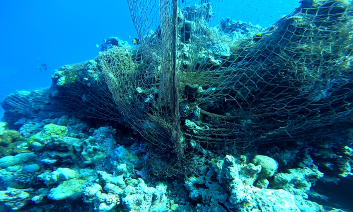 Photo taken by scientists who dived in the water near Ren'ai Jiao shows the fishing net on the east side of the illegally 