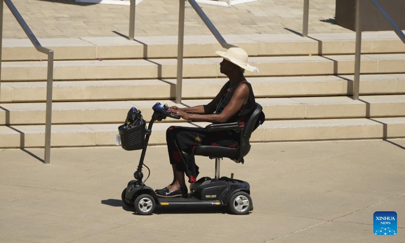 A woman rides a mobility scooter amid heatwave in Sacramento, California, the United States, July 7, 2024. (Photo: Xinhua)