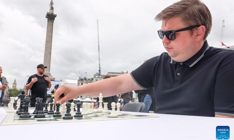 A man plays chess during the ChessFest at the Trafalgar Square in London, Britain, July 7, 2024. ChessFest, an annual open-air chess festival in Britain, took place in London on Sunday. (Photo: Xinhua)