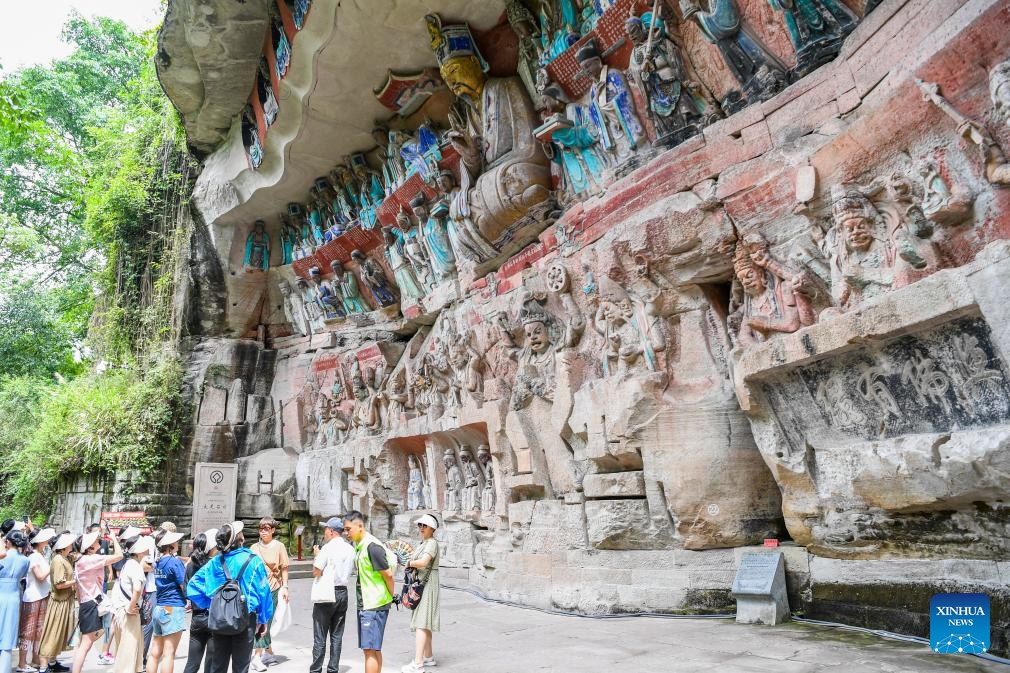 Tourists visit the scenic spot of Dazu Rock Carvings in southwest China's Chongqing, July 7, 2024. The Dazu Rock Carvings site was inscribed onto the UNESCO World Heritage List in 1999. The finest example of Chinese grotto art, the Dazu Rock Carvings site is of profound historical significance, embodying the vigorous vitality of Chinese culture. (Photo: Xinhua)