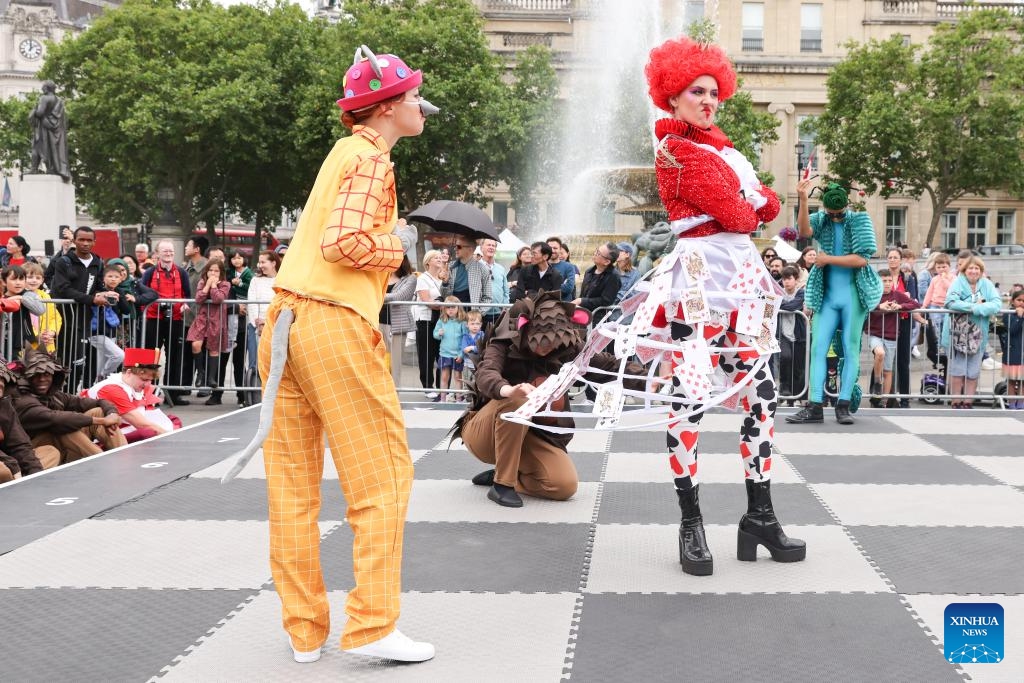 Performers dressed as Alice Through the Looking Glass characters play on a giant chess board during the ChessFest at the Trafalgar Square in London, Britain, July 7, 2024. ChessFest, an annual open-air chess festival in Britain, took place in London on Sunday. (Photo: Xinhua)