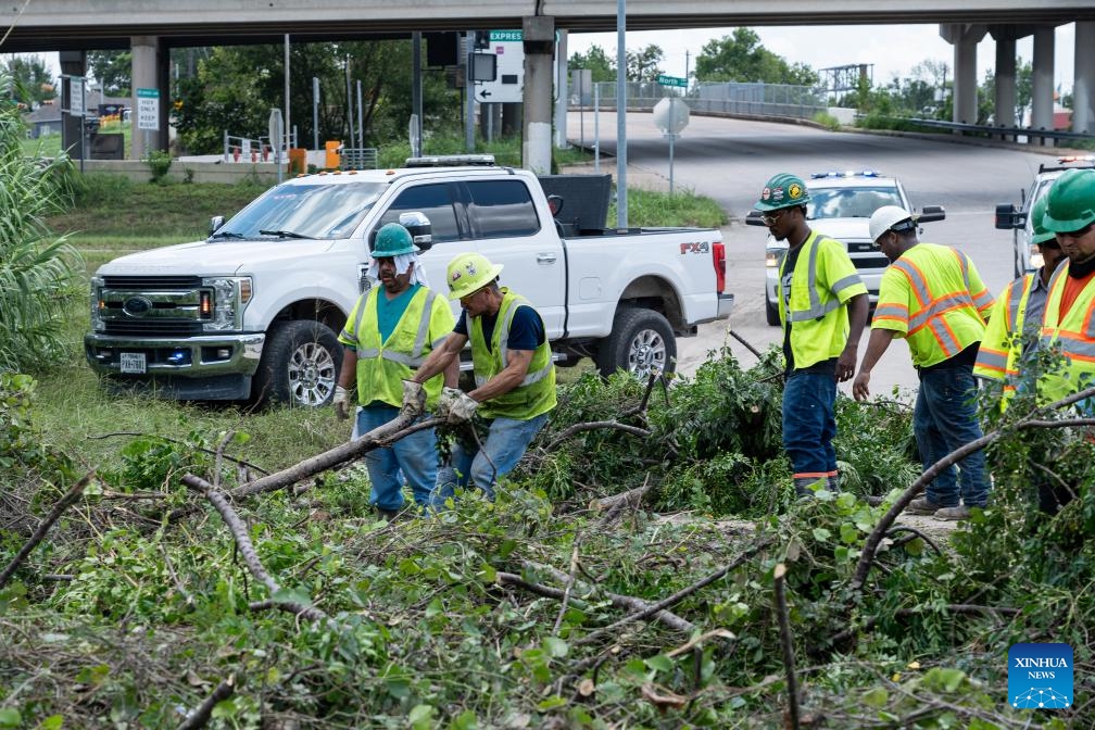 Workers clear debris on a highway after Hurricane Beryl in Houston, Texas, the United States, on July 9, 2024. (Photo: Xinhua)