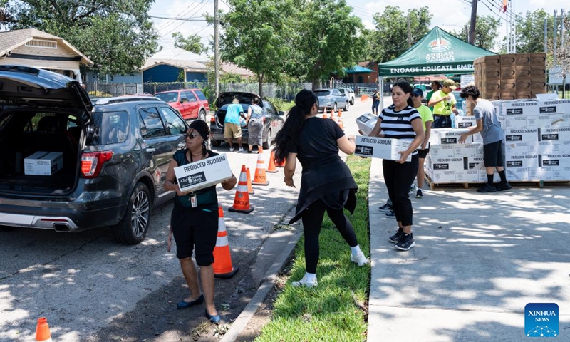 People receive free food at a food distribution site after Hurricane Beryl in Houston, Texas, the United States, on July 9, 2024. (Photo: Xinhua)