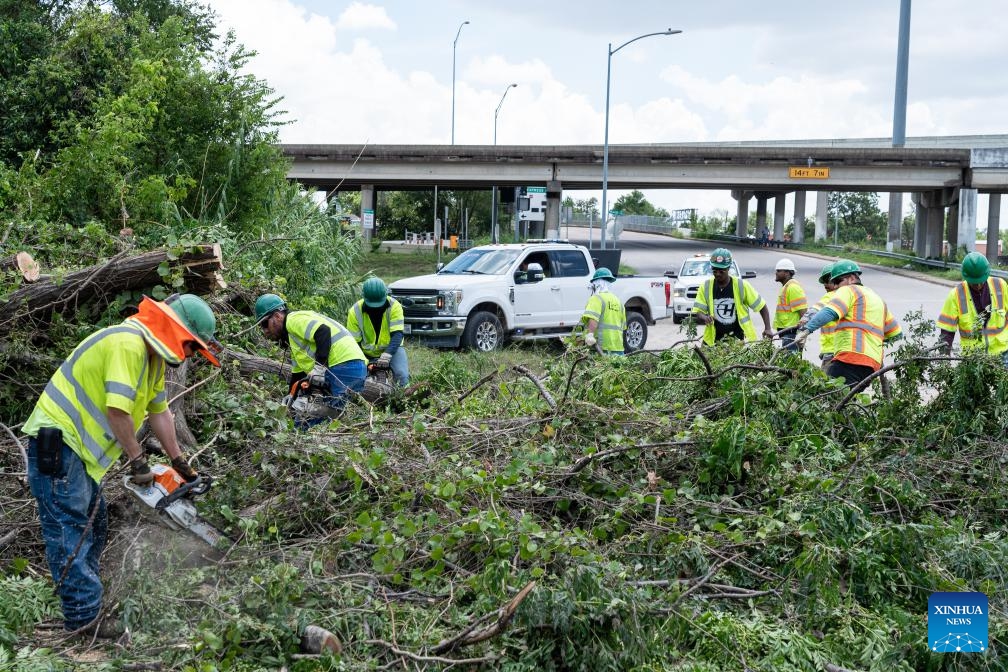 Workers clear debris on a highway after Hurricane Beryl in Houston, Texas, the United States, on July 9, 2024. (Photo: Xinhua)