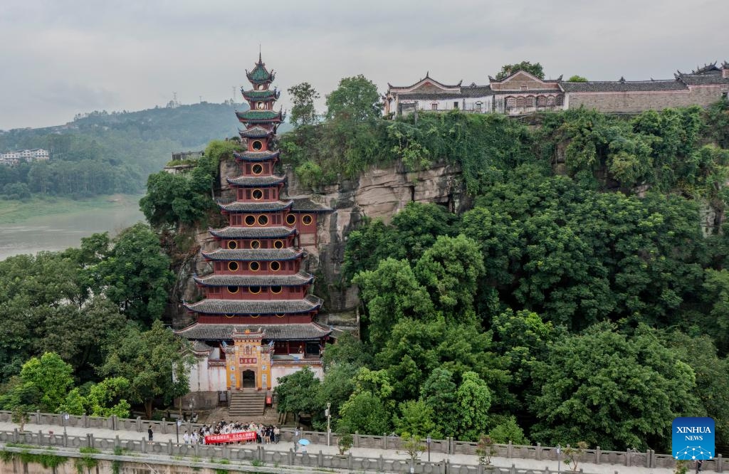 A drone photo taken on July 10, 2024 shows Shibaozhai, a scenic spot in Zhongxian County, southwest China's Chongqing. Shibaozhai looks like a heart-shaped bonsai sitting in the middle of Three Gorges section of Yangtze Rier. It is home to a 12-story, 56-meter wooden pagoda that stands on 20 pillars and leans against the cliff. This structure dated back to the Ming Dynasty (1368-1644) serves as a leading tourist attraction of Shibaozhai. (Photo: Xinhua)