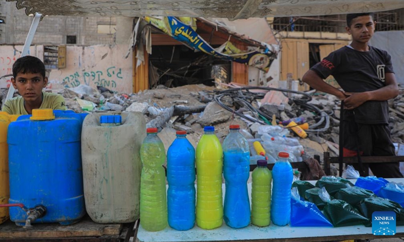 Palestinians sell locally produced soap in bottles in the southern Gaza Strip city of Khan Younis, on July 9, 2024. Palestinians suffer from the lack of soap and body cleansers in the markets. (Photo: Xinhua)