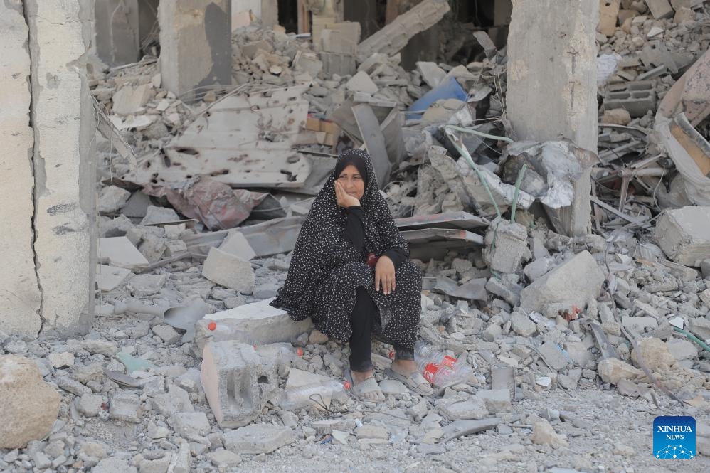 A woman sits among the rubble in the Shujaiya neighborhood in east of Gaza City, on July 11, 2024. More than 60 bodies were recovered from the rubble in the eastern Gaza City neighborhood of Shujaiya after a prolonged Israeli ground offensive, the Palestinian official news agency WAFA reported on Thursday. (Photo: Xinhua)