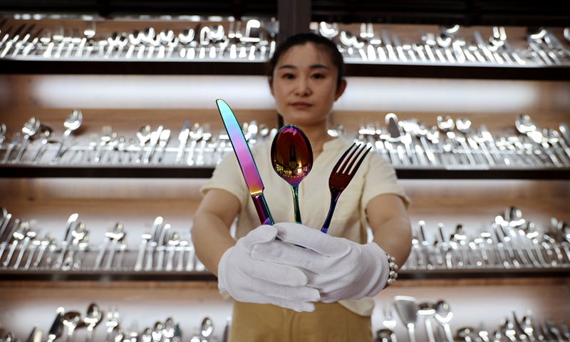 A staff member displays Western tableware in a showroom of a tableware production enterprise in Yangxin county, East China's Shandong Province on July 11, 2024. The county mainly produces Western tableware covering more than 30 product categories with over 20,000 kinds of specifications, with products exported to more than 30 countries and regions. Photo: VCG 