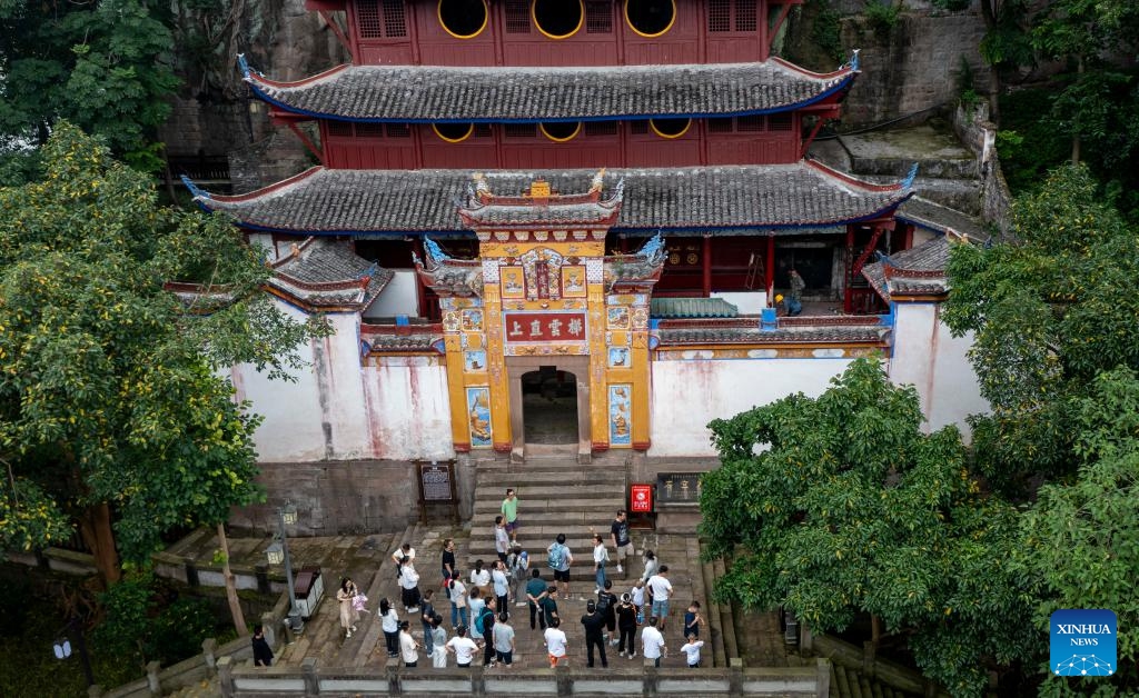 A drone photo taken on July 10, 2024 shows people visiting the Shibaozhai, a scenic spot in Zhongxian County, southwest China's Chongqing. Shibaozhai looks like a heart-shaped bonsai sitting in the middle of Three Gorges section of Yangtze Rier. It is home to a 12-story, 56-meter wooden pagoda that stands on 20 pillars and leans against the cliff. This structure dated back to the Ming Dynasty (1368-1644) serves as a leading tourist attraction of Shibaozhai. (Photo: Xinhua)