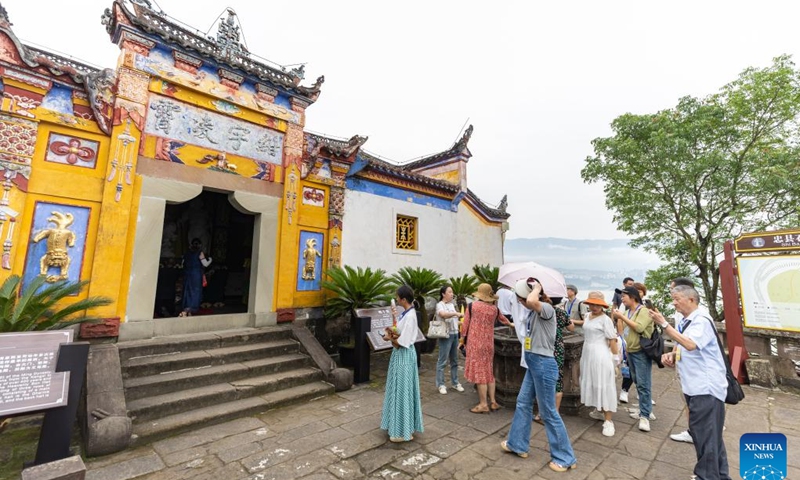 People visit Shibaozhai, a scenic spot in Zhongxian County, southwest China's Chongqing, July 10, 2024. Shibaozhai looks like a heart-shaped bonsai sitting in the middle of Three Gorges section of Yangtze Rier. It is home to a 12-story, 56-meter wooden pagoda that stands on 20 pillars and leans against the cliff. This structure dated back to the Ming Dynasty (1368-1644) serves as a leading tourist attraction of Shibaozhai. (Photo: Xinhua)