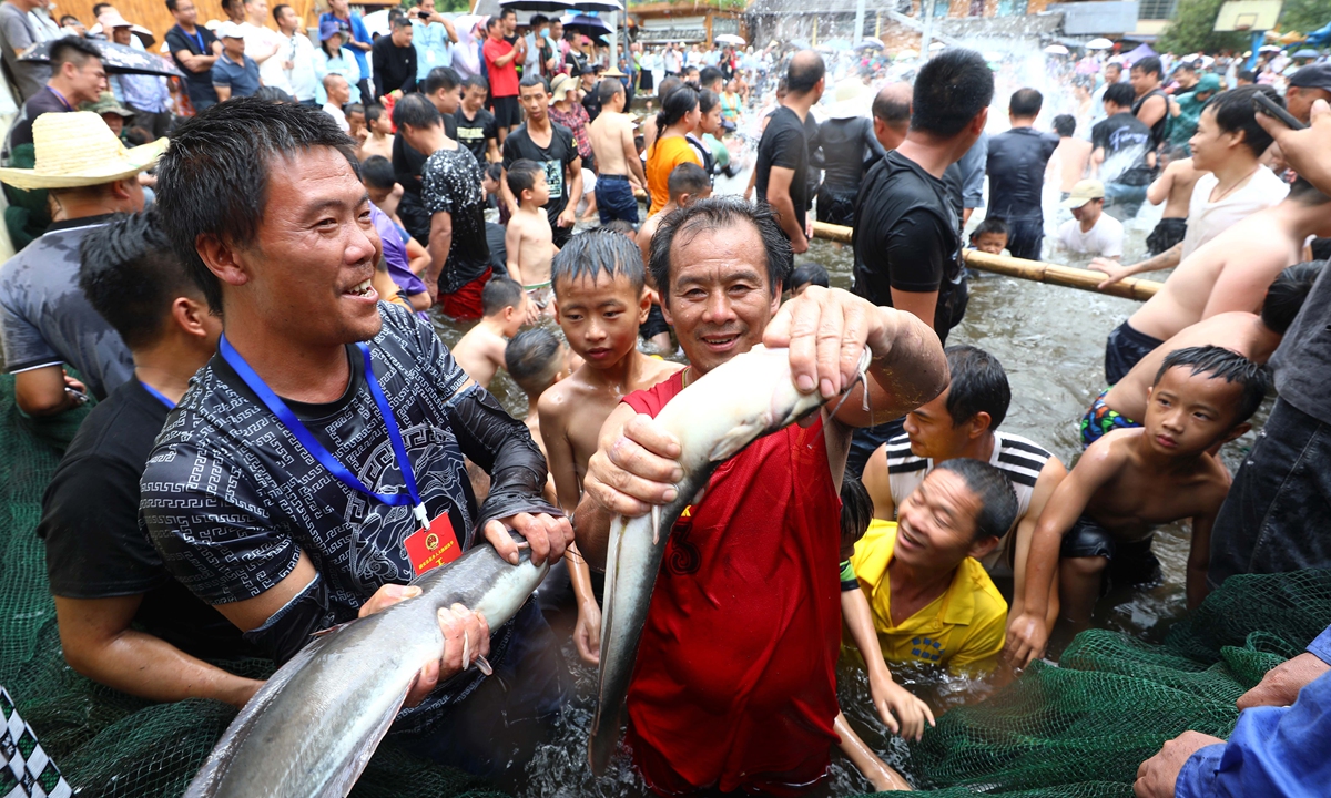 Tourists and local residents participate in a fish festival in a village in Liuzhou, South China's Guangxi Zhuang Autonomous Region, on July 11, 2024, the sixth day of the sixth month of the lunar Chinese calendar. The annual event is a traditional festival for the Miao ethnic group to pray for a bumper harvest, prosperity, and well-being for humans and animals. Photo: VCG