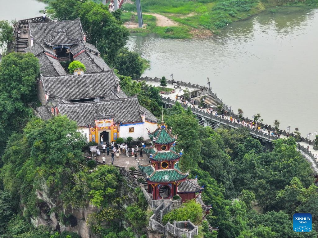 A drone photo taken on July 10, 2024 shows Shibaozhai, a scenic spot in Zhongxian County, southwest China's Chongqing. Shibaozhai looks like a heart-shaped bonsai sitting in the middle of Three Gorges section of Yangtze Rier. It is home to a 12-story, 56-meter wooden pagoda that stands on 20 pillars and leans against the cliff. This structure dated back to the Ming Dynasty (1368-1644) serves as a leading tourist attraction of Shibaozhai. (Photo: Xinhua)