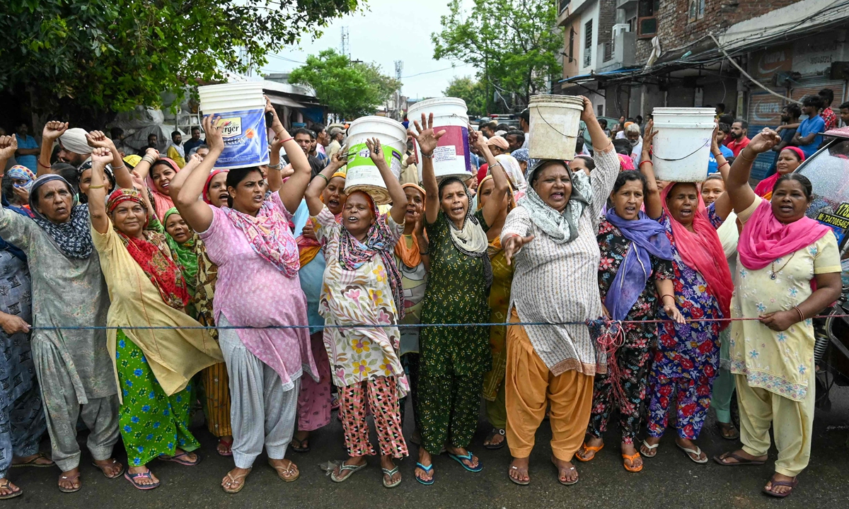 Women hold empty buckets as they block a street to protest against the paucity of water in Amritsar, India, on July 12, 2024. Months of scorching temperatures, sometimes exceeding 50 C in parts of India this year, left hundreds dead or ill, media reports said. It has been described as India's worst heat wave in over a decade. Photo: VCG