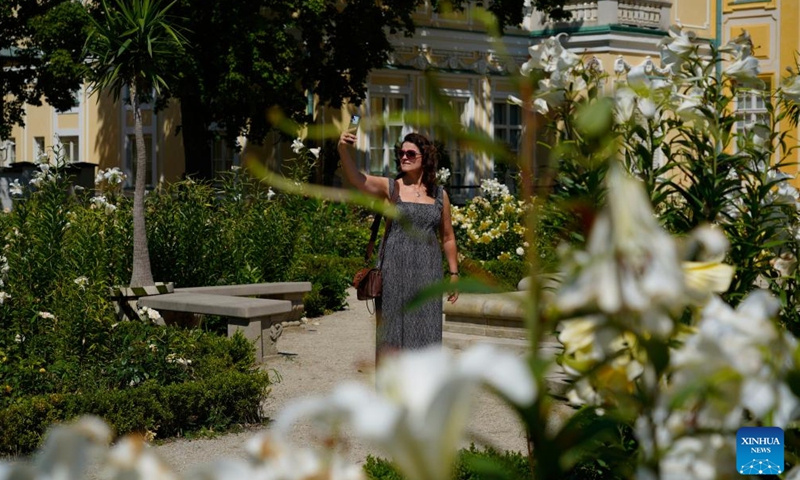 A visitor takes photos at a garden of Wilanow Palace in Warsaw, Poland, July 13, 2024. Photo by Jaap Arriens/Xinhua)