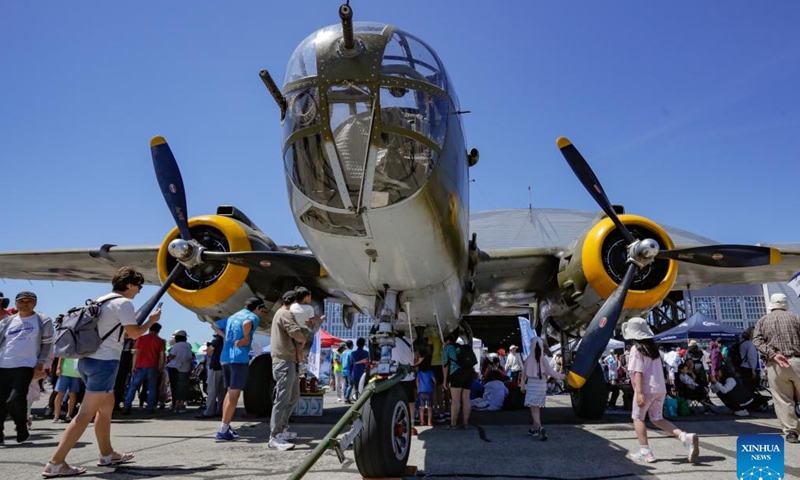 People view a bomber displayed at the 2024 Boundary Bay Airshow in Delta, British Columbia, Canada, on July 13, 2024.This annual airshow opened here on Saturday, featuring aerobatic performances and static displays of both modern and vintage airplanes. (Photo by Liang Sen/Xinhua)