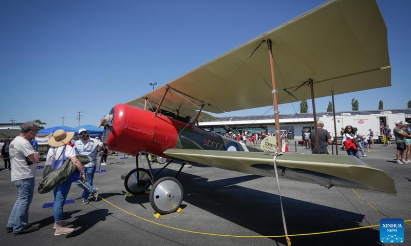 People view a vintage aircraft displayed at the 2024 Boundary Bay Airshow in Delta, British Columbia, Canada, on July 13, 2024.This annual airshow opened here on Saturday, featuring aerobatic performances and static displays of both modern and vintage airplanes. (Photo by Liang Sen/Xinhua)