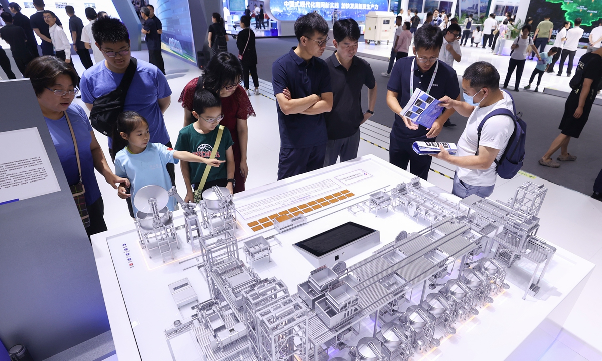 Visitors look at a miniature model of a liquor distillery on display at the 26th China Beijing International High-tech Expo on July 14, 2024. More than 300 exhibitors from home and abroad attended the expo, demonstrating some 1,000 of their latest achievements of sci-tech innovation. Photo:cnsphoto