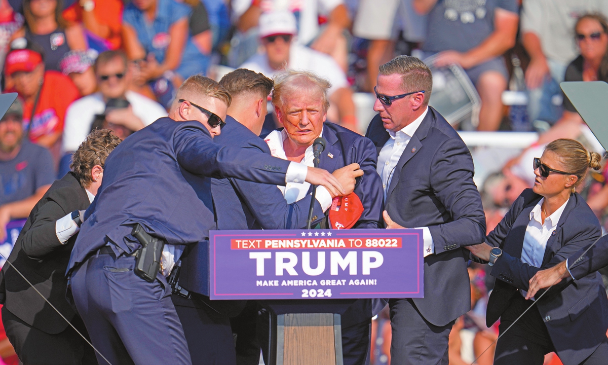 Republican presidential candidate and former US president Donald Trump is helped off the stage at a campaign event in Butler, Pennsylvania on July 13, 2024 local time. Trump was injured in a shooting in what the FBI says was an assassination attempt. Photo: VCG