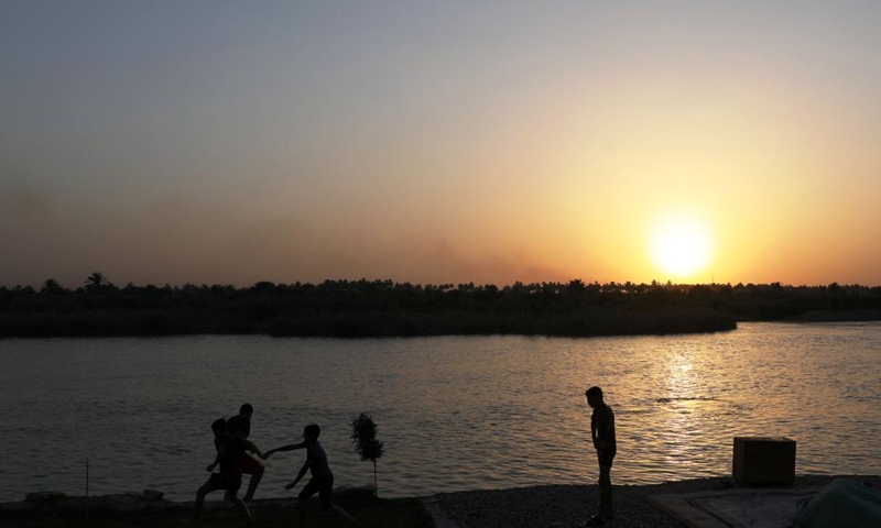 Children have fun at sunset on the bank of Tigris River in Baghdad, Iraq. (Xinhua/Khalil Dawood)