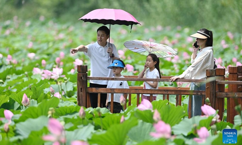 Tourists visit a wetland scenic spot of Weishan Lake in Tengzhou, east China's Shandong Province, July 14, 2024. Many tourist destinations across China have recently seen a surge in visitors as the country enters its peak summer tourist season. (Photo by Li Zhijun/Xinhua)