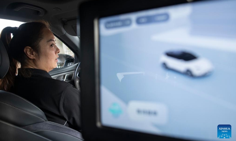 Intelligent connected vehicle tester Wang Juan is pictured during a road test in Wuhan, central China's Hubei Province, July 4, 2024. 