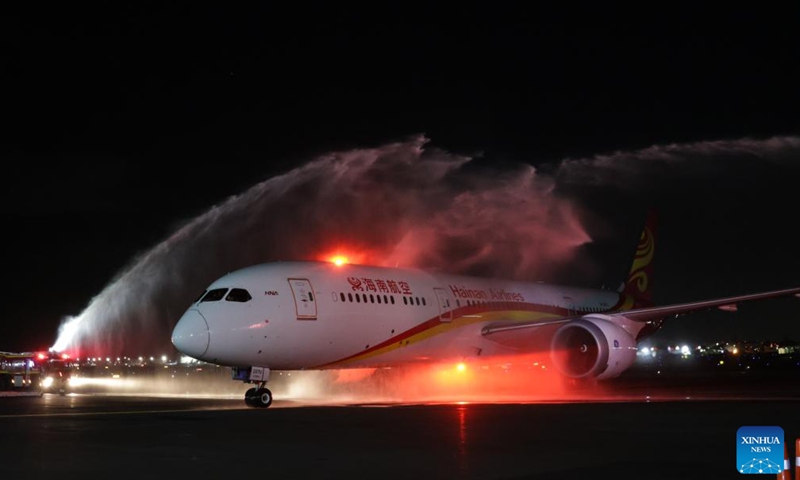 A passenger aircraft of China's Hainan Airlines passes a welcome water gate at the Benito Juarez International Airport in Mexico City, Mexico, July 13, 2024.