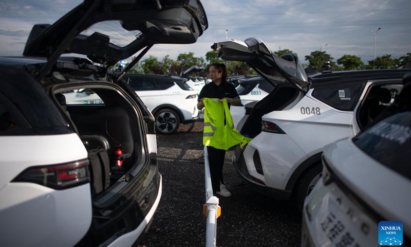 Intelligent connected vehicle tester Wang Juan prepares for a road test in Wuhan, central China's Hubei Province, July 4, 2024. 