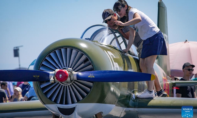 People view an aircraft displayed at the 2024 Boundary Bay Airshow in Delta, British Columbia, Canada, on July 13, 2024.This annual airshow opened here on Saturday, featuring aerobatic performances and static displays of both modern and vintage airplanes. (Photo by Liang Sen/Xinhua)