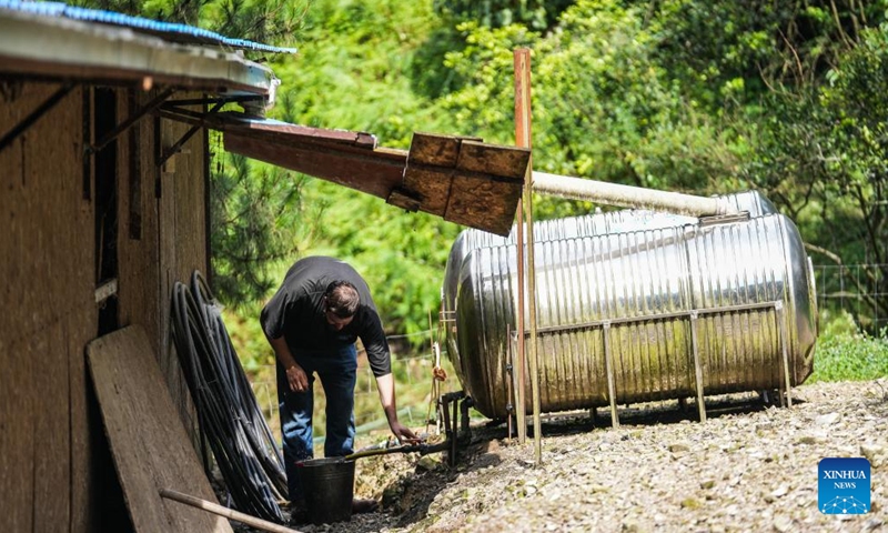 Kevin Cillen Michael E. fetches water from a rainwater collector at his farm in Xiasi Village, Dushan County, southwest China's Guizhou Province, June 13, 2024.