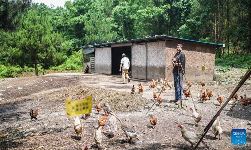 Kevin Cillen Michael E. (R) and his father are seen at his farm in Xiasi Village, Dushan County, southwest China's Guizhou Province, June 13, 2024. (Xinhua/Tao Liang)