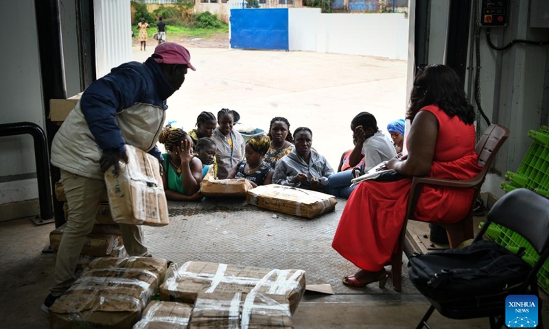 Local residents and dealers purchase aquatic products at a Chinese-built aquatic products processing and storage complex in Bissau, Guinea-Bissau, on July 8, 2024.